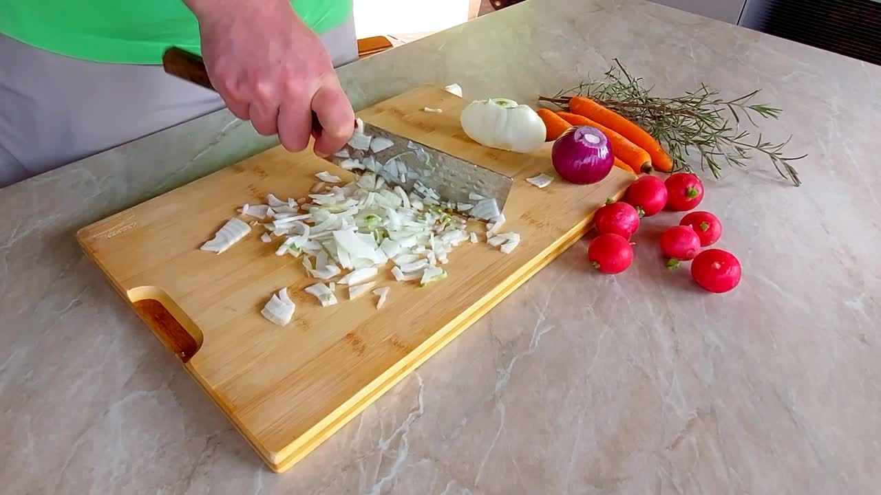 Slicing Onion on Bamboo wooden plank