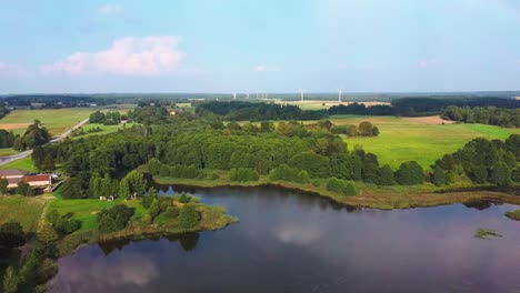 panorama of alsunga city lake with large wind turbines for electric power production in latvia-3