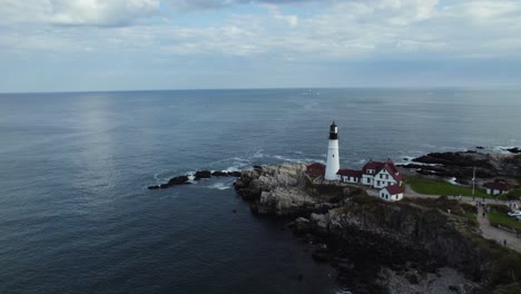 portland head light lighthouse on calm rocky maine coastline, aerial