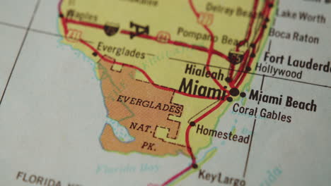 the camera pans across a paper map of florida and stops on miami