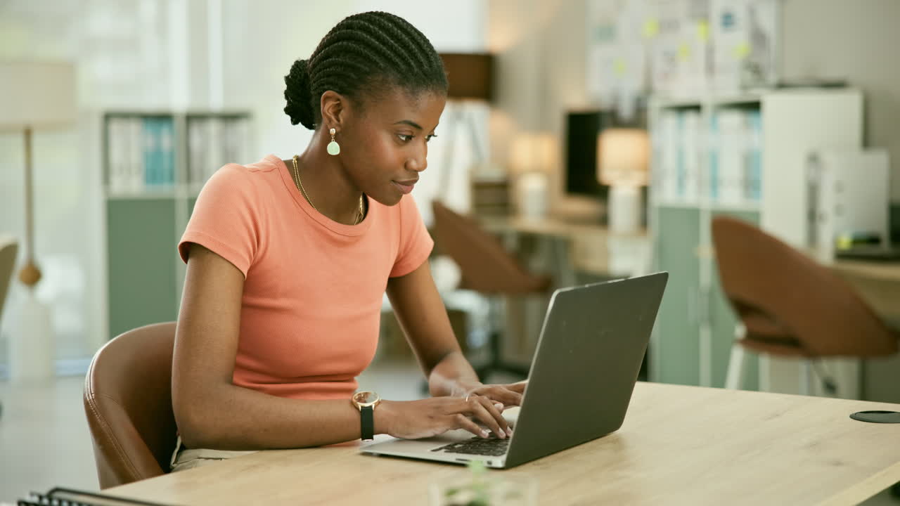 Woman Working on Laptop in Modern Office