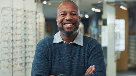 optician smiling and looking at camera in his store