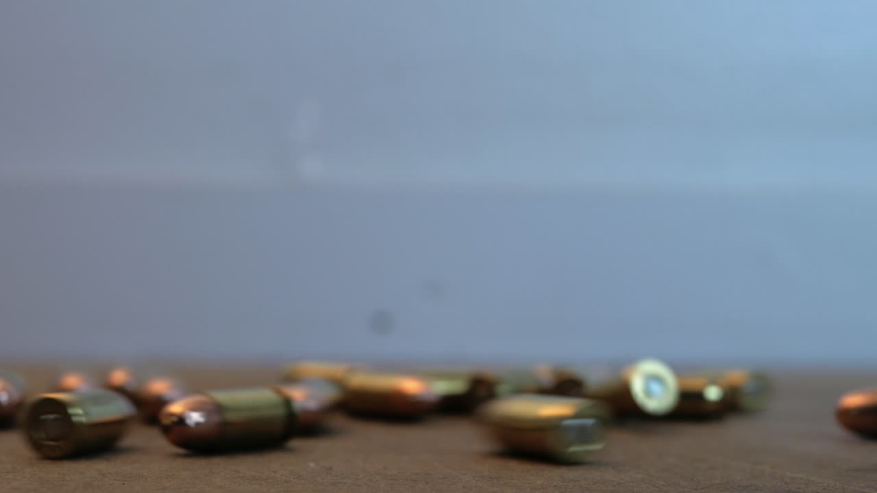 pistol ammo rolling on a table
