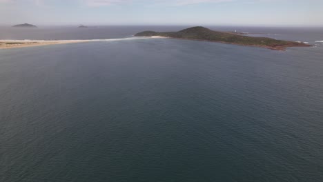 seascape with fingal island in new south wales, australia - aerial drone shot