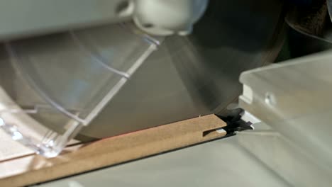 close-up of working on a machine with a circular saw