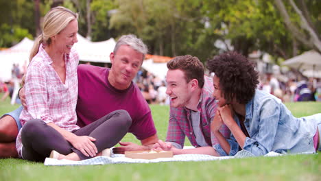 Two-couples-relaxing-together-at-an-outdoor-event