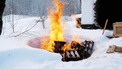 burning wood in a snow-covered area