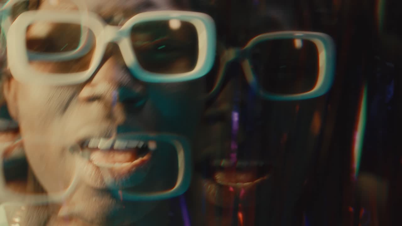 Kaleidoscopic Effect of Black Rapper Giving Hip-Hop Performance in Neon Lights