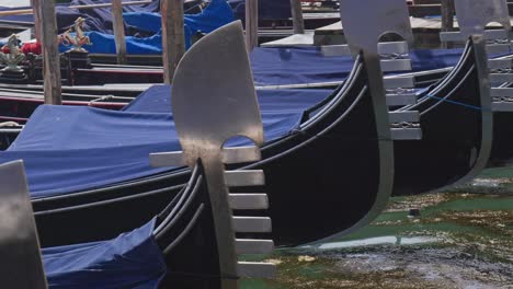 gondola boats bobbing rhythm on waves of venetian lagoon mooring dock