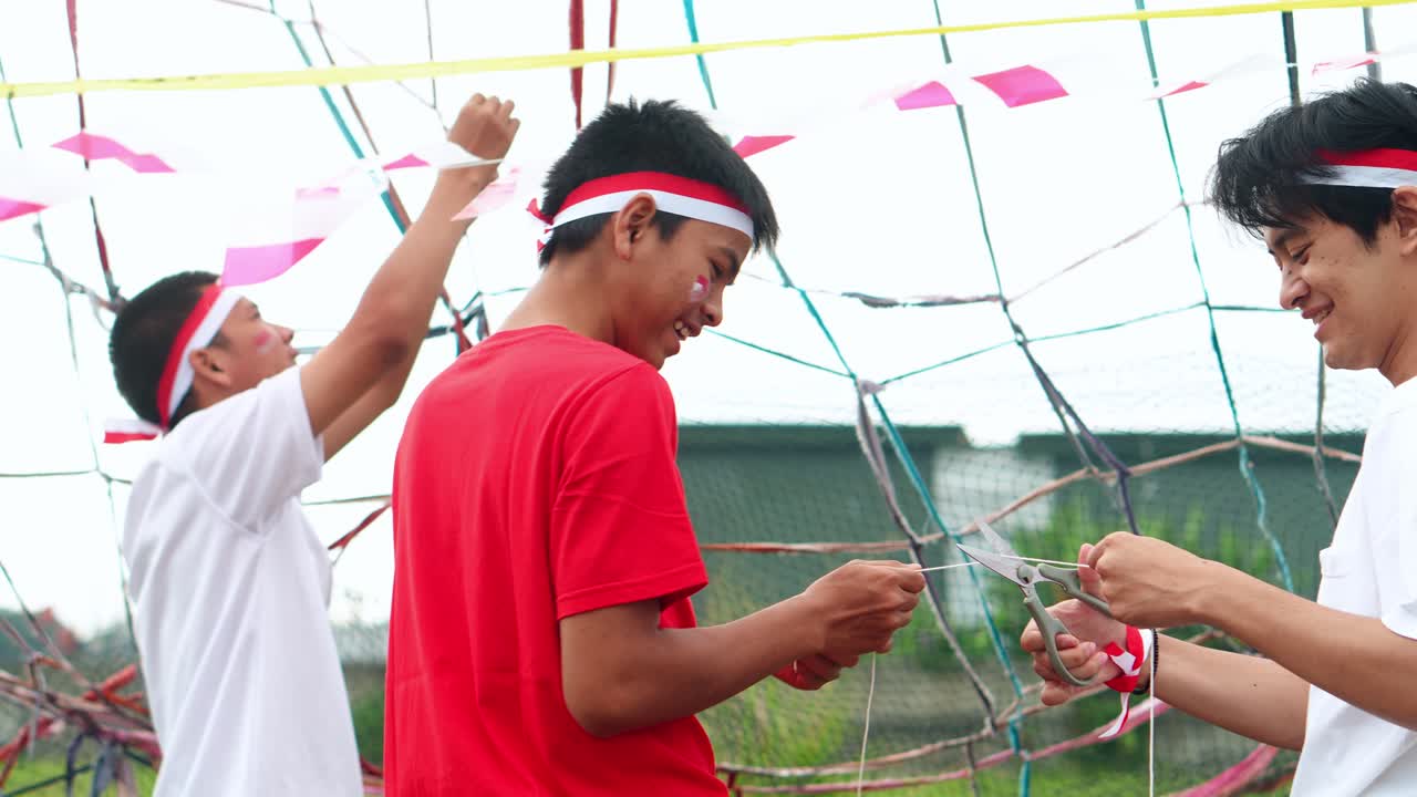 Young Indonesian Men Cheerfully Preparing Decorations For Independence Day Celebrations