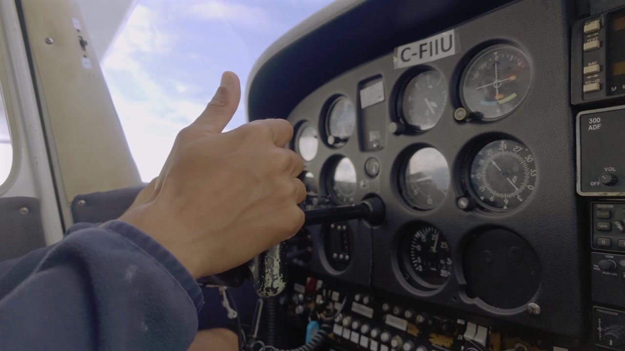 Pilot Adjusting Throttle Control In Cessna Flight Deck During Flight Operations. - closeup shot