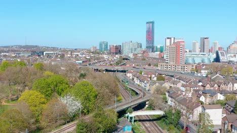 drone shot towards central croydon passing over green tram