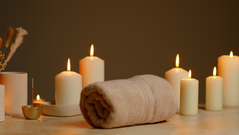 still life of lit candles with dried grasses incense stick and soft towels as part of relaxing spa day decor 8