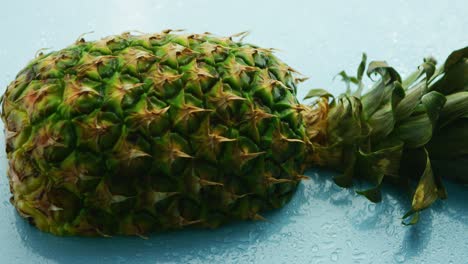 Half-of-pineapple-on-wooden-table