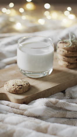vertical video of mug of milk and christmas cookies and copy space on white background