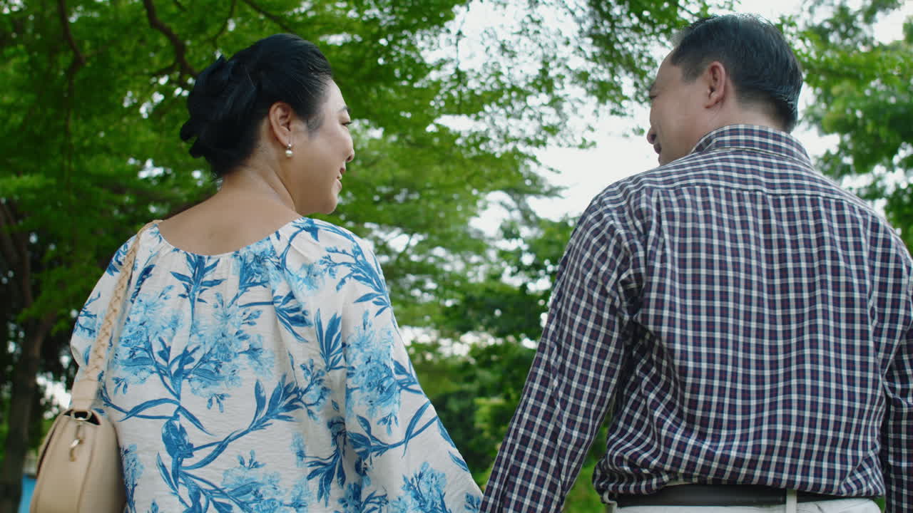 Mature Asian Couple Having Romantic Date in City Park