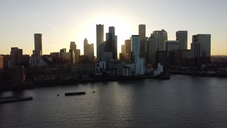 aerial - sunset over river thames and canary wharf, london, uk, wide pan right