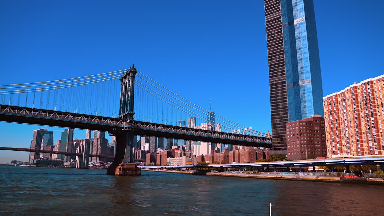 View on the waterfront of New York near the Manhattan Bridge. City skyline against clear sky at backdrop