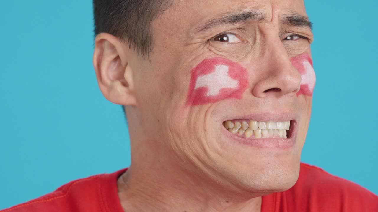 Very nervous man supporting swiss team during a difficult match