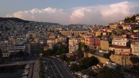 Aerial-approaching-ancient-roman-aqueduct-in-modern-city-in-Greece