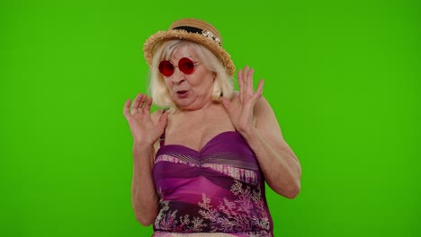 happy senior woman in swimsuit on green screen