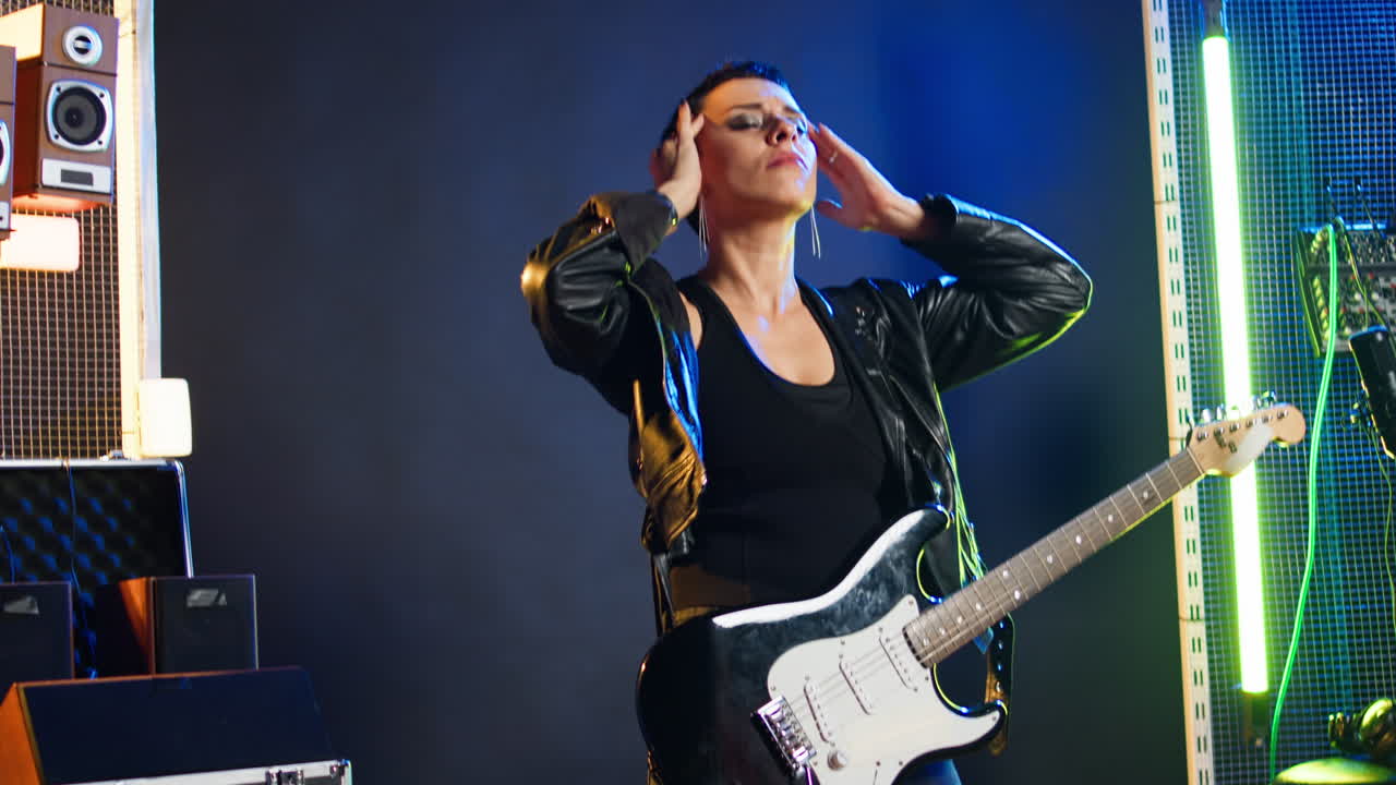 Woman playing electric guitar on stage
