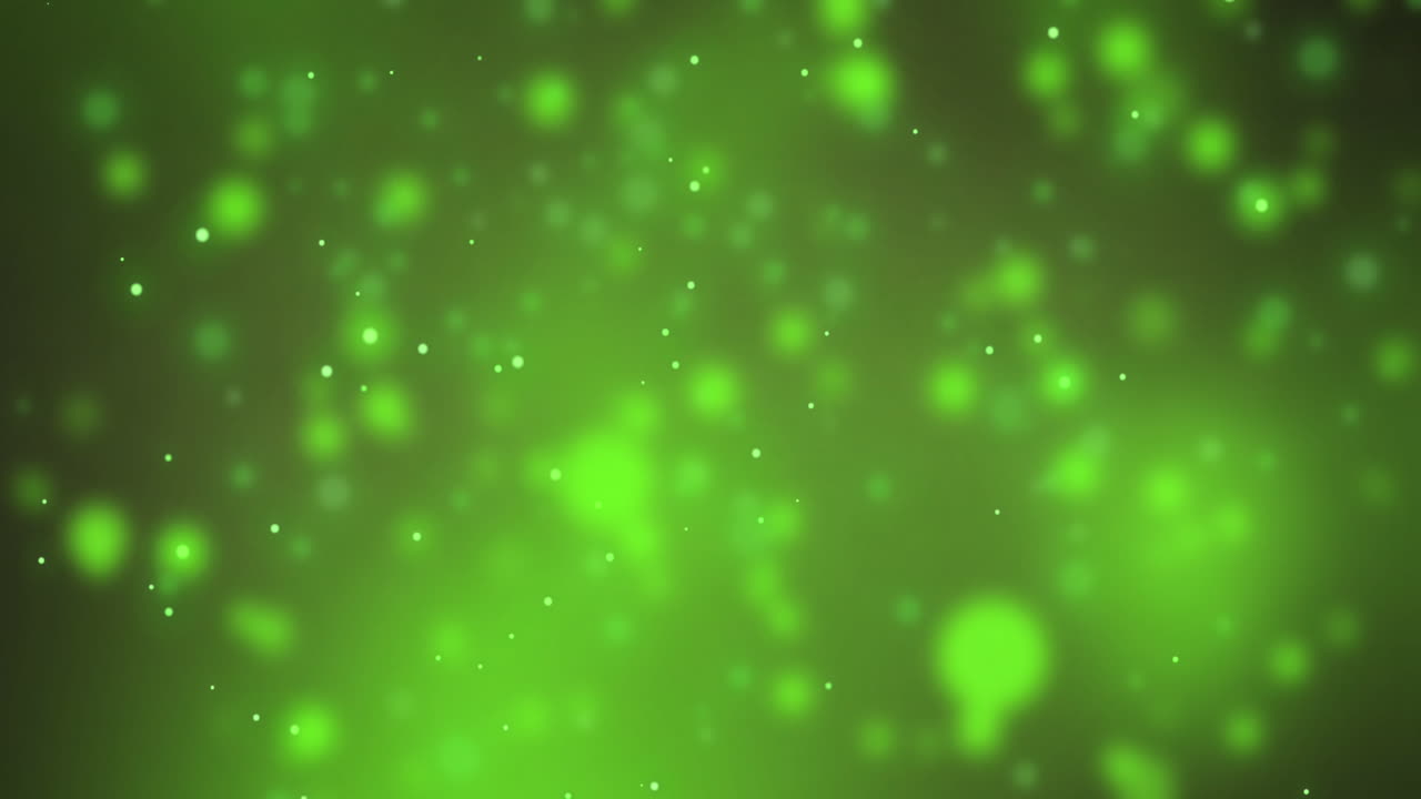 Animation af faldende sne over lyspletter på grøn baggrund