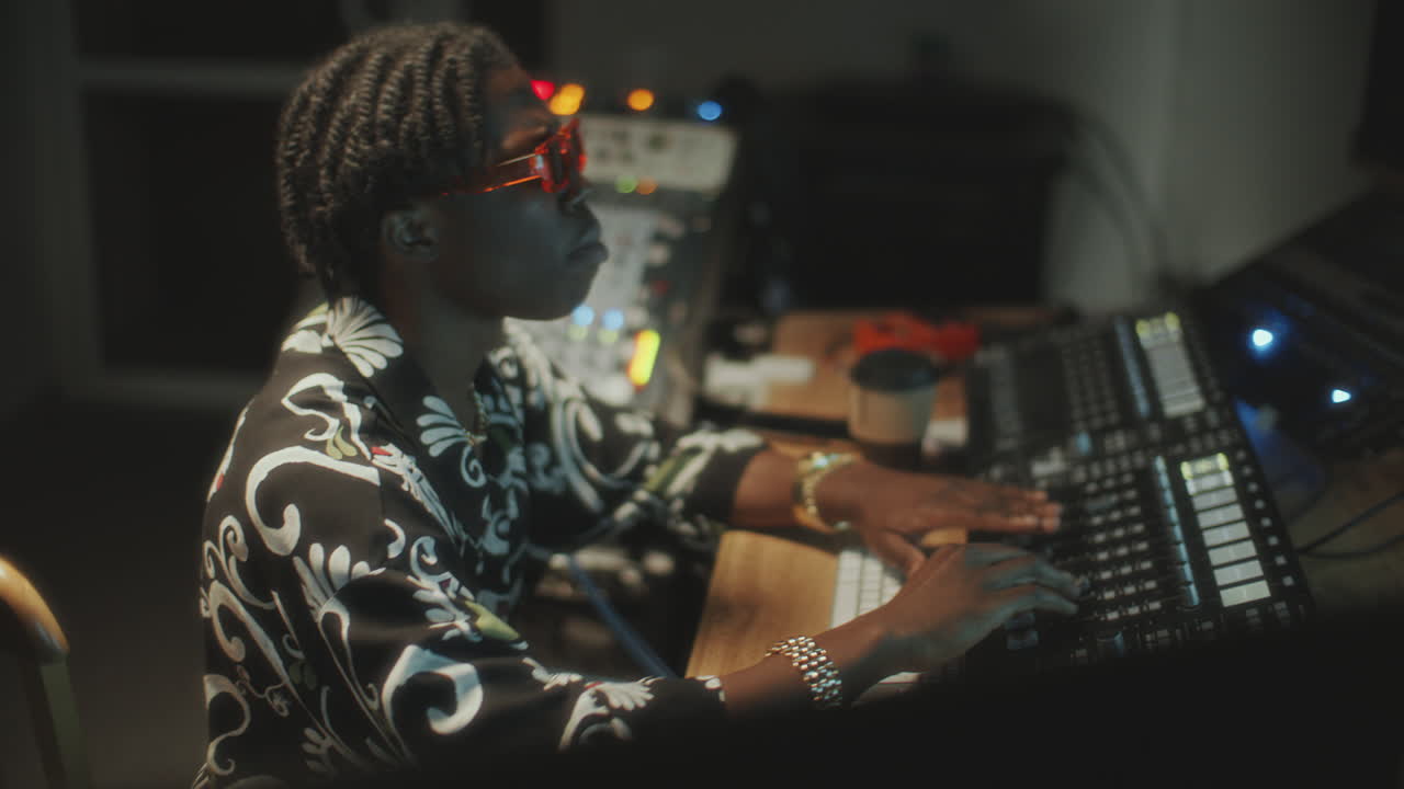 African American Sound Engineer Mixing Audio in Music Recording Studio