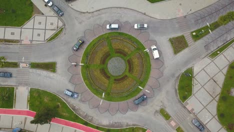Cars are moving in a circular motion top view. Roundabout cars