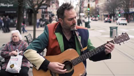 a passionate street musician enchants passersby with his acoustic guitar melodies in a vibrant urban setting, showcasing artistic talent and emotion