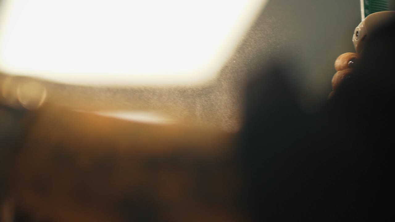 Hair Stylist Spraying Hair with Fine Mist