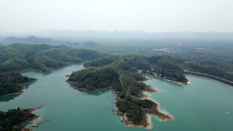 aerial view of a serene lake with green islands and hills