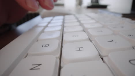 Close-up-Moving-Macro-Shot:-Man-hands-typing-on-laptop-keyboard-working-on-Internet-project-at-light-workplace.-Online-content.-Digital-marketing.-Business-intelligence.-Digital-analytics.