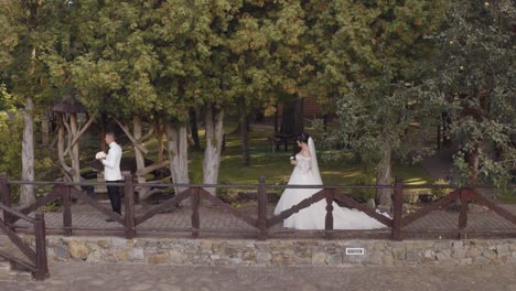 Lovely-newlyweds-caucasian-bride-and-groom-with-bouquet-in-park,-wedding-couple-first-meeting