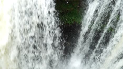 camera filming down into a large waterfall in java