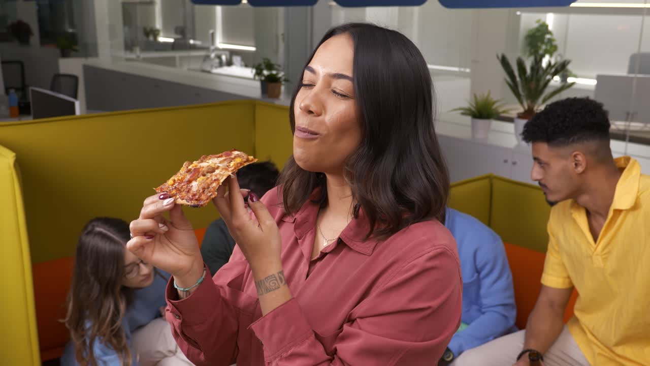 Office worker enjoying pizza during break time