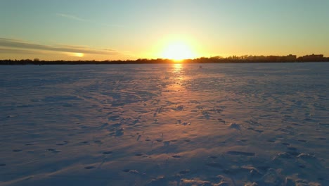 sun setting over the horizon in a frozen lake, amazing winter sunset in north america, nature outdoors