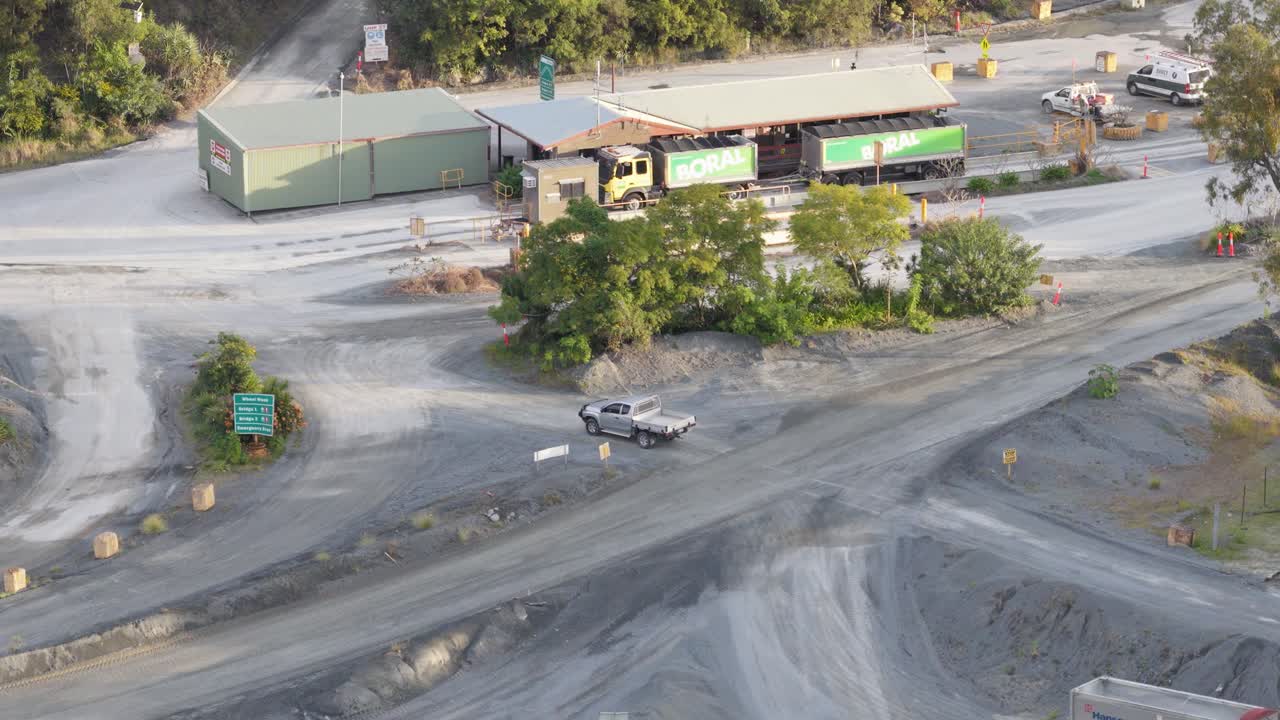 Drone captures a utility vehicle navigating a quarry site in Gold Coast, Australia, under bright daylight