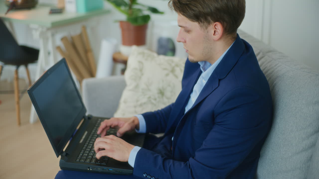 Businessman Typing on Laptop