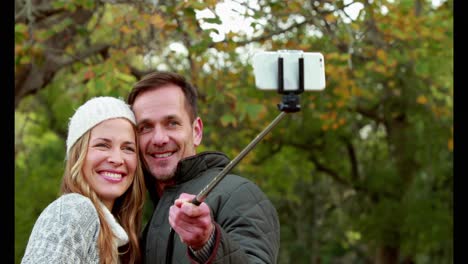 couple taking selfie on autumns day in park