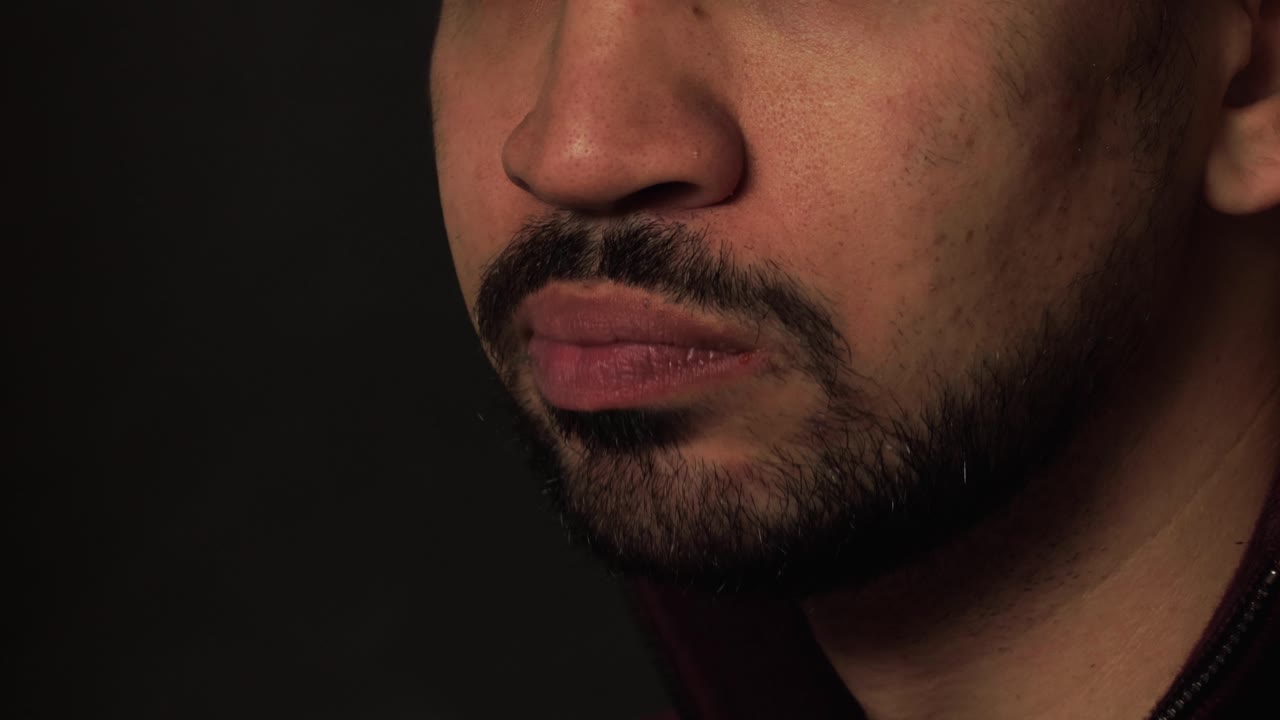 A close-up of man enjoying a cheesy slice of pizza, capturing the deliciousness of Italian food, casual dining experiences.