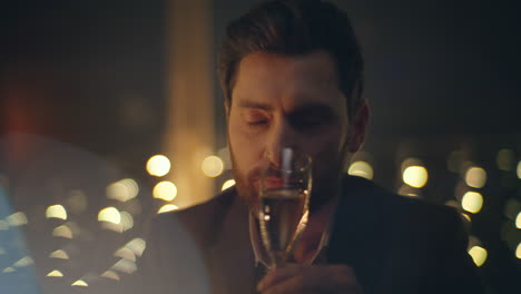 rich man tasting champagne romantic date dark room closeup. guy drinking alcohol