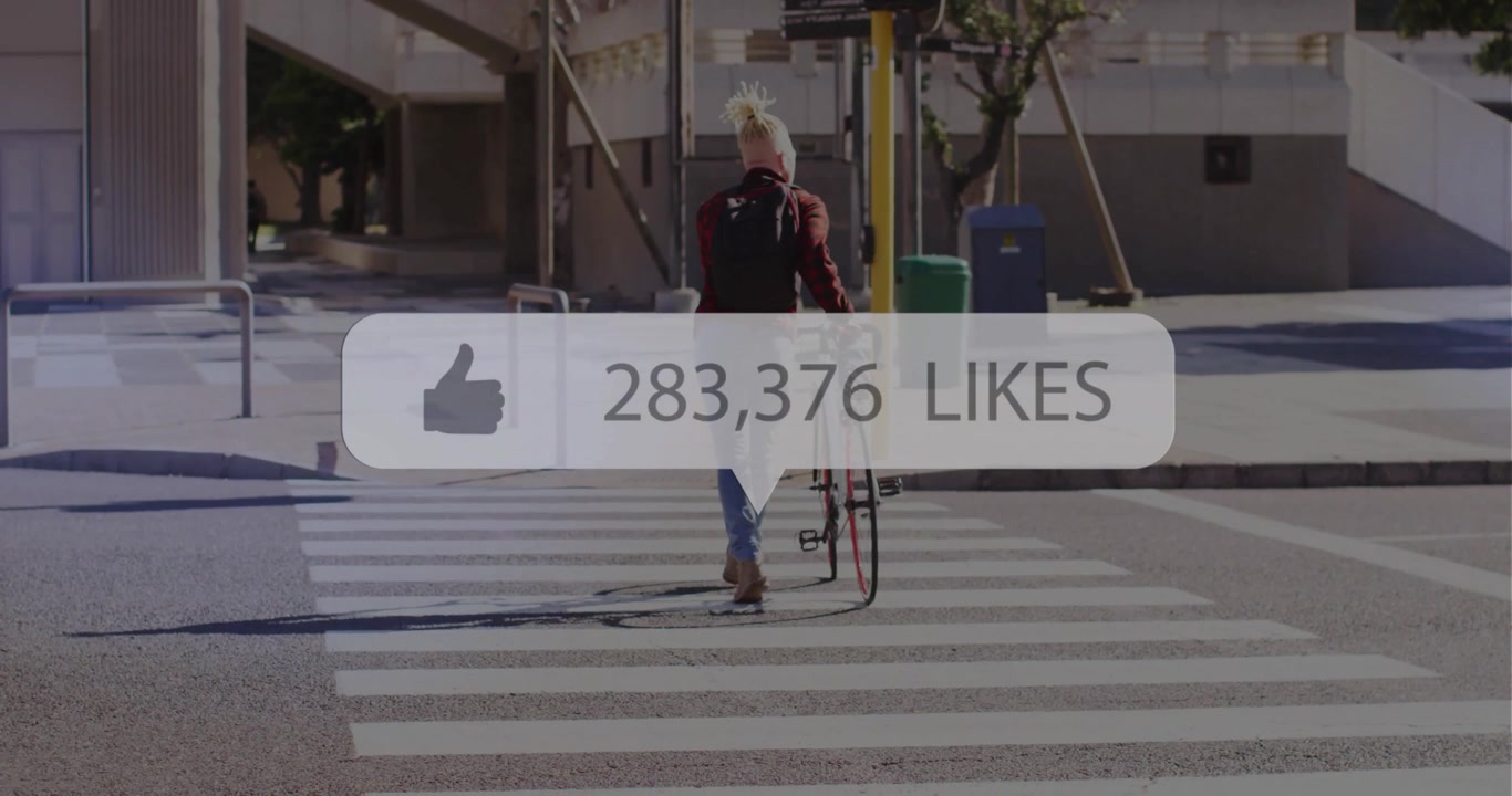 Man pushing bicycle across urban crossing, displaying semi-transparent social media likes overlay