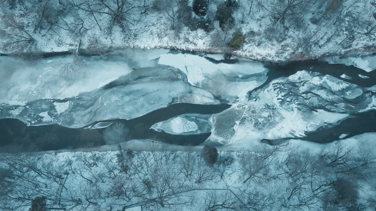 Snowy aerial winter view of icy river in Mississauga, Canada