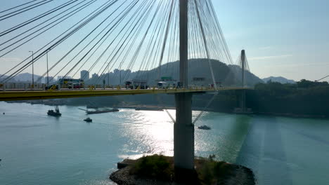 traffic drives over the ting kau bridge during sunny morning