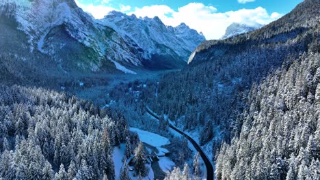 Drone-Aerial-view-of-mountains-and-forest-with-snow-in-winter