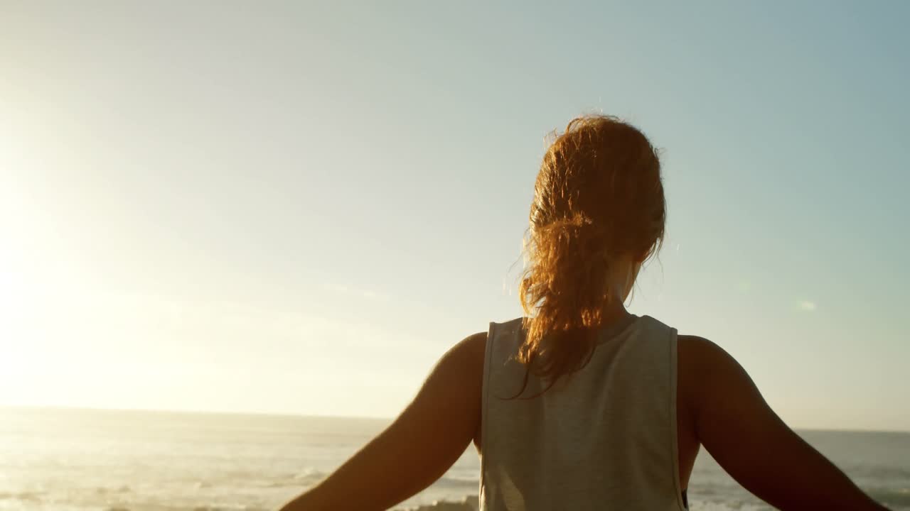 Woman exercising in the beach 4k
