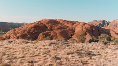 Orbiting-aerial-of-dead-brush-surrounding-a-hill-in-Utah's-Snow-Canyon