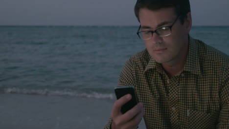 Man-Using-Smartphone-by-the-Sea