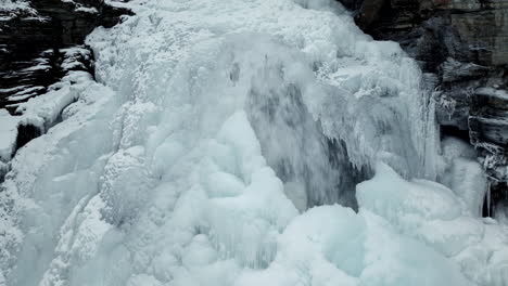 craggy mountain with frozen cascades during winter in northern norway